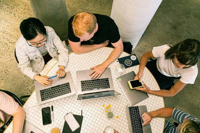 a diverse group of professionals actively participating in an online forum discussion, representing community engagement and expert contributions